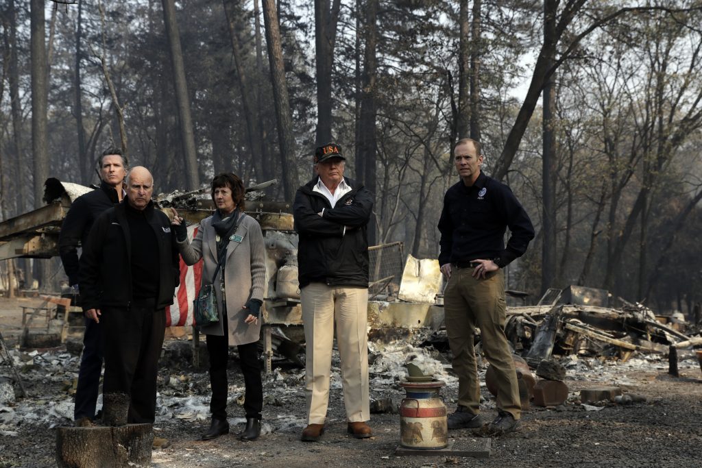 Donald Trump President Donald Trump talks with from left, Gov.-elect Gavin Newsom, California Gov. Jerry Brown, Paradise Mayor Jody Jones and FEMA Administrator Brock Longduring a visit to a neighborhood destroyed by the wildfires, Saturday, Nov. 17, 2018, in Paradise, Calif. (AP Photo/Evan Vucci)