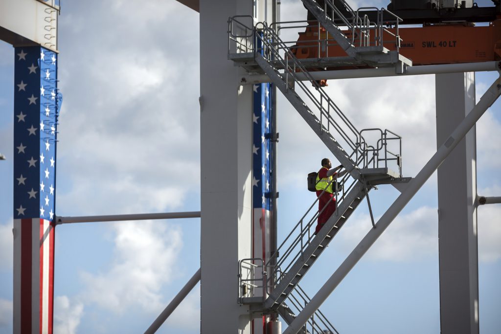 Global Economy Slowdown In this July, 5, 2018, file photo, a rubber tire gantry operator climb steps to his cab at the start of his work shift at the Port of Savannah in Savannah, Ga. (Stephen B. Morton/AP Photo)