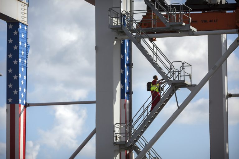 In this July, 5, 2018, file photo, a rubber tire gantry operator climb steps to his cab at the start of his work shift at the Port of Savannah in Savannah, Ga. (Stephen B. Morton/AP Photo)
