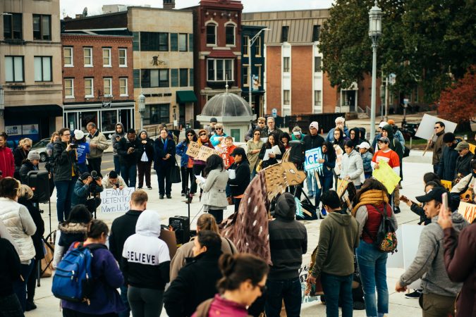 A crowd on the Capitol steps listens to women read excerpts from interviews with mothers detained at Berks County Residential Center. (Dani Fresh for WHYY)