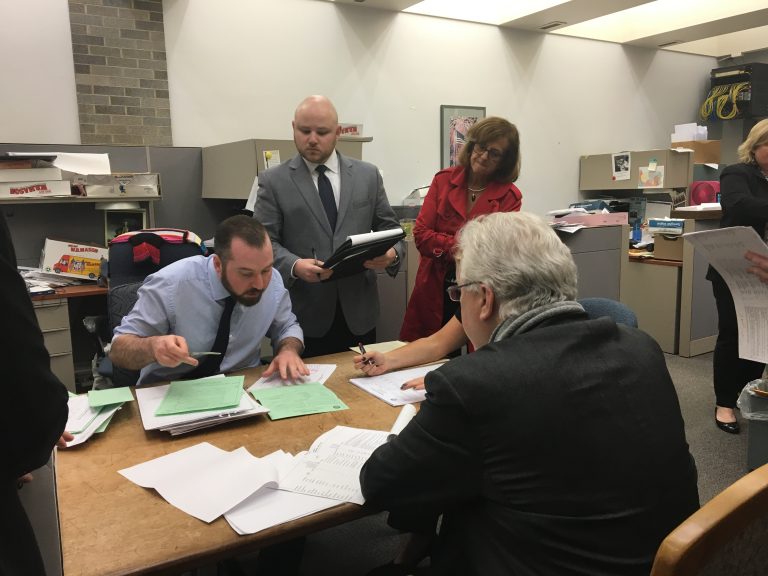 Election workers pore over Pennsylvania Senate's 6th District race in the Bucks County Courthouse. (Katie Meyer/WITF)
