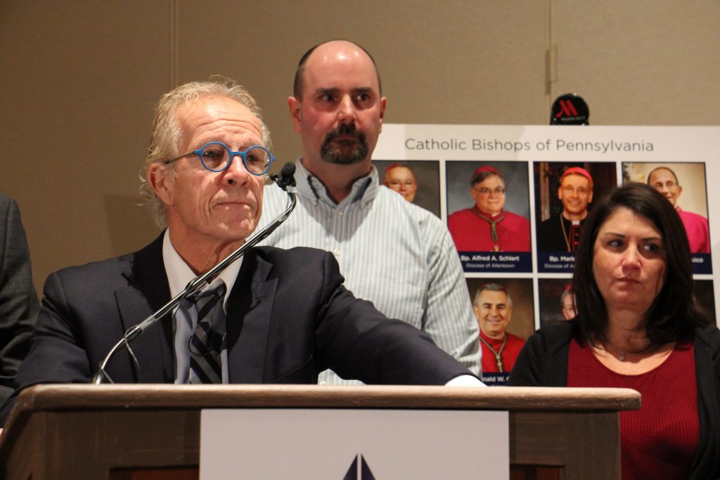 Image uploaded from iOS Attorney Jeff Anderson announces a suit against the Pennsylvania’s eight Catholic dioceses on behalf of victims of clergy child sexual abuse. He is joined by victim Daniel Hillanbrand and Hillanbrand’s wife, Donna. (Emma Lee/WHYY)