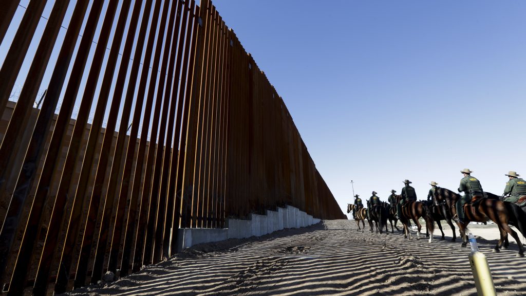 Mounted Border Patrol agents ride along a newly fortified border wall structure in Calexico, Calif. Funding for the border wall is one of a number of administration priorities that may face challenges if the Democrats flip the House. Mounted Border Patrol agents ride along a newly fortified border wall structure in Calexico, Calif. Funding for the border wall is one of a number of administration priorities that may face challenges if the Democrats flip the House. (Gregory Bull/AP)