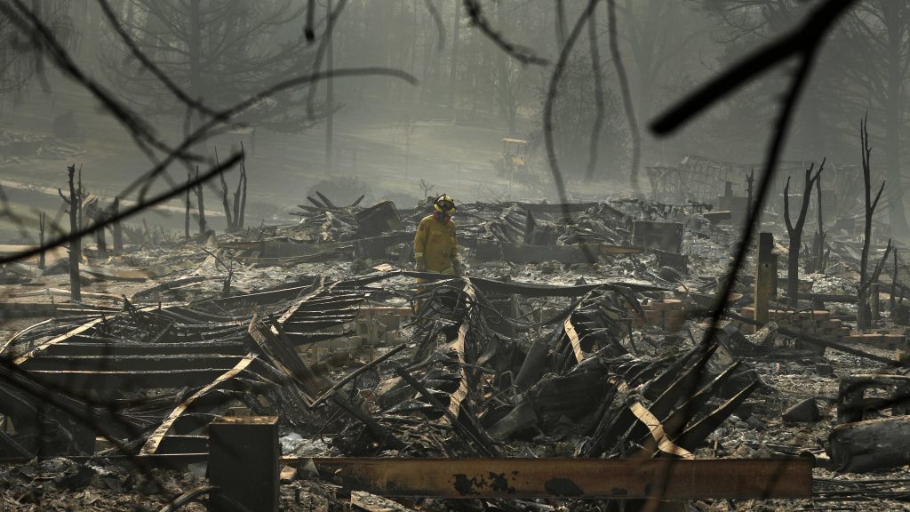 A firefighter searches a trailer park destroyed in the Camp Fire on Friday Paradise, Calif. A firefighter searches a trailer park destroyed in the Camp Fire on Friday Paradise, Calif. (John Locher/AP)
