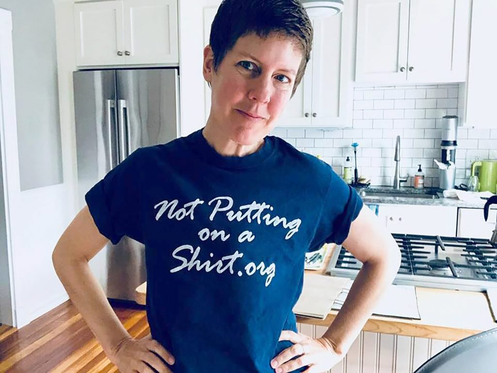 Catherine Guthrie decided not to get breast reconstruction after her double mastectomy in 2009. Here she’s wearing a t-shirt from Not Putting on a Shirt, a grassroots advocacy organization that brings attention to the issue of surgeons disregarding breast cancer patients’ wishes to go flat.