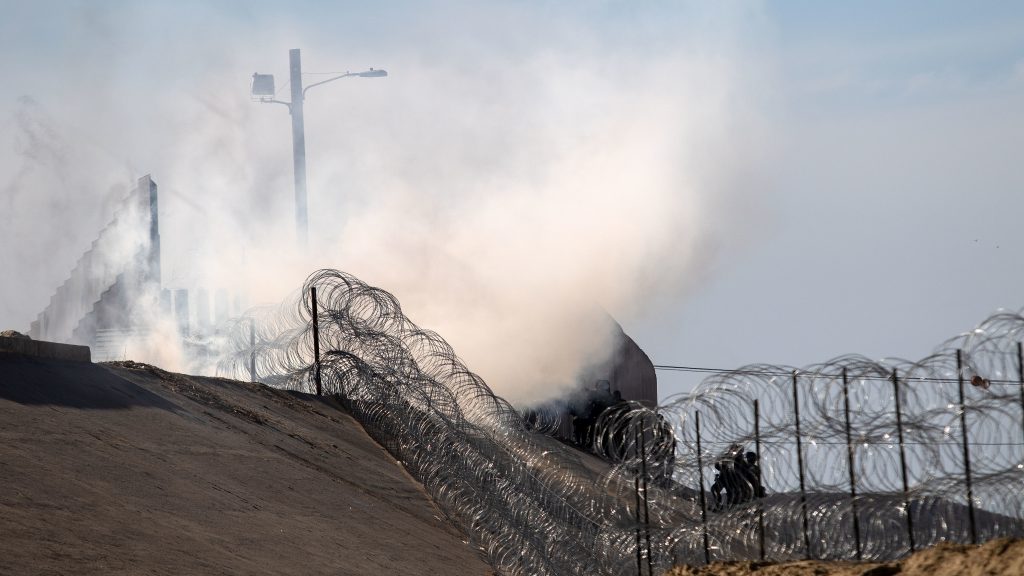 Tear gas thrown by the U.S. Border Patrol is seen near the El Chaparral/San Ysidro border crossing in Tijuana, Mexico, on Sunday. Tear gas thrown by the U.S. Border Patrol is seen near the El Chaparral/San Ysidro border crossing in Tijuana, Mexico, on Sunday