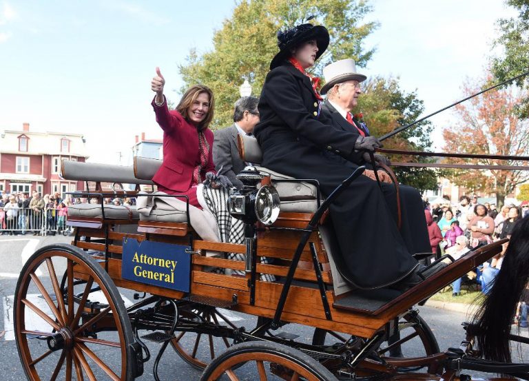 Kathy Jennings waves to the Return Day crowd in 2018, two days after being elected attorney general, while riding in a horse-drawn carriage from  Marvel Carriage Museum. (WHYY file)