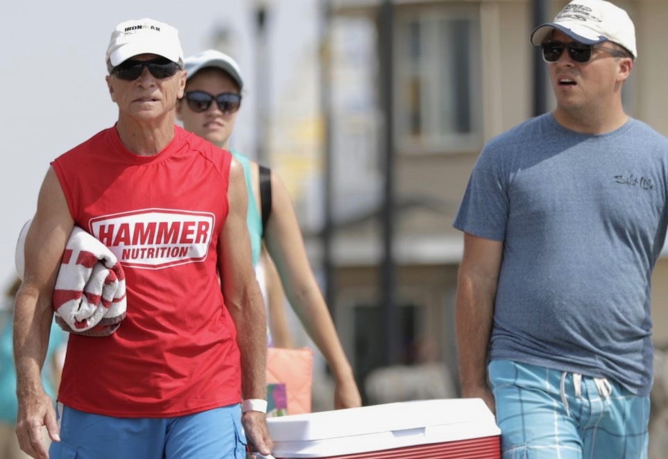 People carry a cooler while strolling at the boardwalk on their way to a beach spot at the New Jersey shore, Friday, Aug. 17, 2018, in Seaside Heights, N.J. (Julio Cortez / AP Photo)