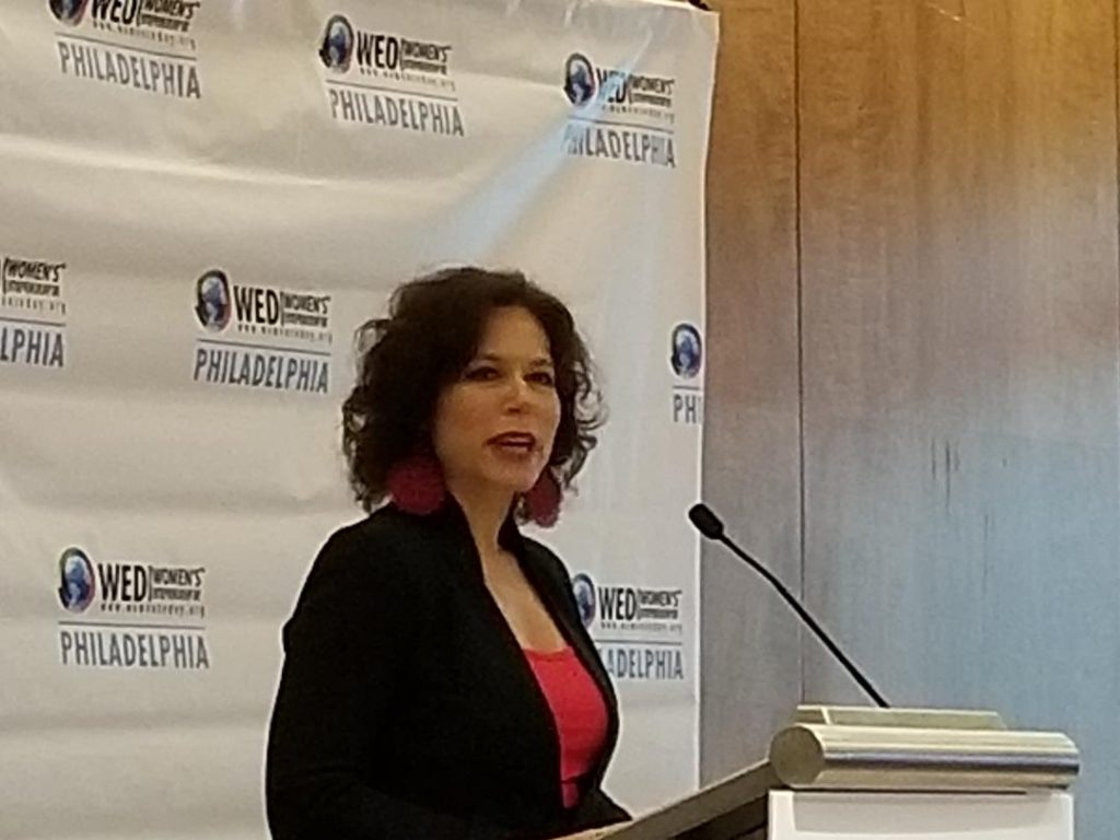 pic 1 Women's Entrepreneurship Day conference organizer Elisa Bloom speaks to attendees in Philadelphia Monday. (Tom MacDonald/WHYY)