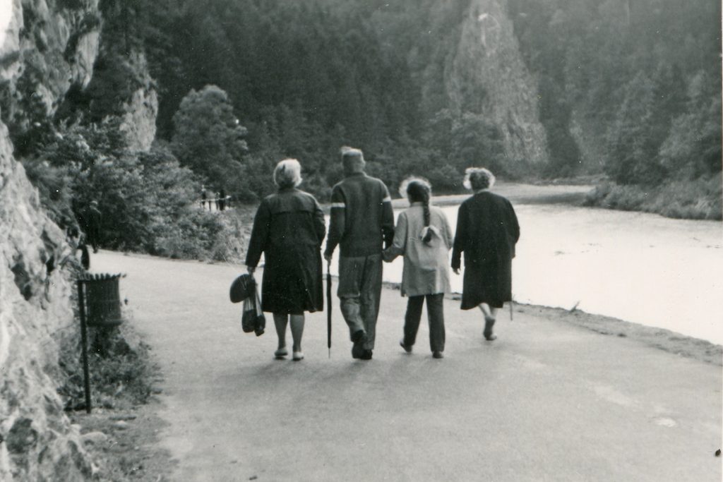 Vintage photo of happy three generations family walking