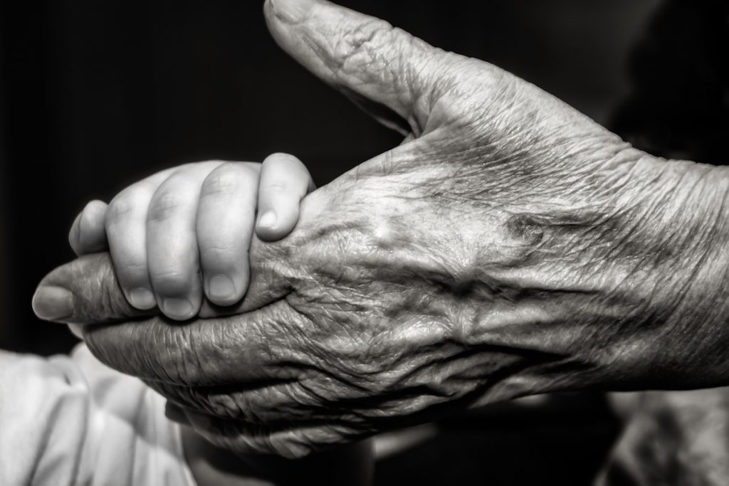 Childs Hand And Old Wrinkled Skin Palm Finger Concept Idea Of Love Family Protecting Children And El
