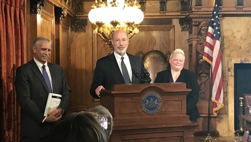 Governor Tom Wolf, flanked by outgoing budget secretary Randy Albright and his replacement, Jen Swails. (Katie Meyer/WITF)