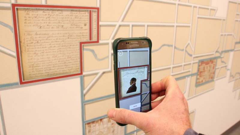 The City Archives mural is enhanced by an augmented reality app, which supplements the experience with illustrations, animations and information. (Emma Lee/WHYY)