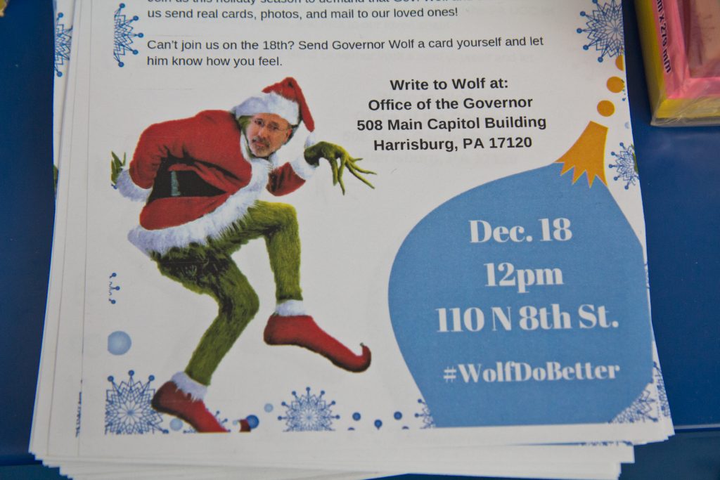 2018 12 10 k paynter card making for gov wolf-3 A grinch Governor Wolf appears on a flyer inviting Philadelphians to create holiday cards to send to Governor Wolf asking him to end a DOC policy that doesn’t allow families to send cards of photos to incarcerated family members. (Kimberly Paynter/WHYY)