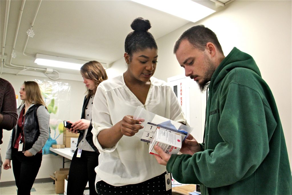 Charles Greif, 27, accepts a naloxone pack from Philadelphia health department worker Fatimah Maiga at Holmsburg Library, one of 80 sites across Pennsylvania where the overdose reversal drug was distributed for free.