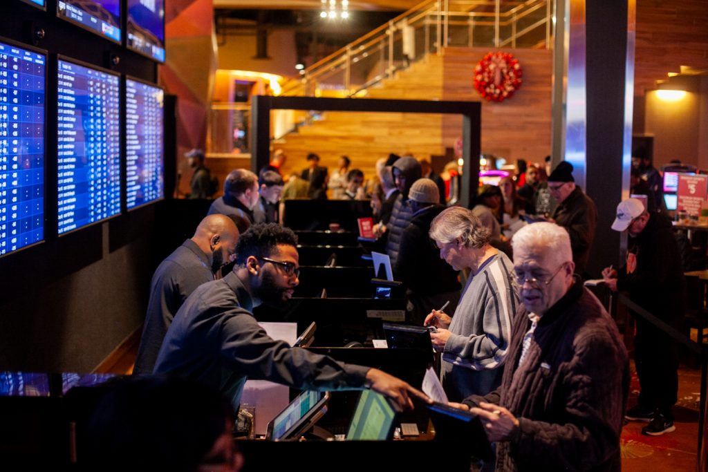 2018 12 15- b larrison- philadelphia- mark squilla cheryl duhon- sports betting opens at sugar house casino -8 Prospective bettors place their wagers on sports events at the SugarHouse Casino Saturday morning. (Brad Larrison for WHYY)