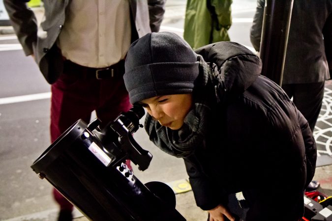 The Philadelphia Moon Men invite people on the streets of Philadelphia to gaze at the moon. (Kimberly Paynter/WHYY)