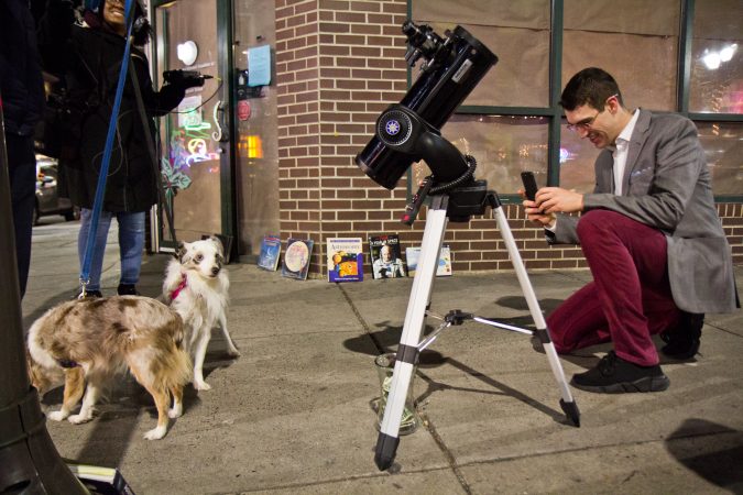 Brendan Happe photographs dogs at 4th and South Streets. (Kimberly Paynter/WHYY)