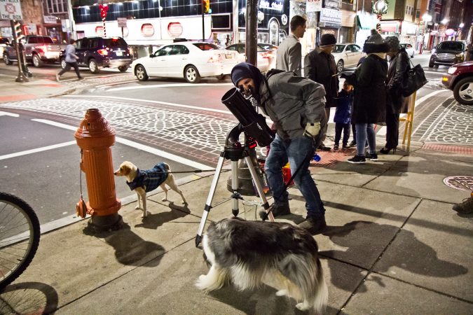 The Philadelphia Moon Men invite people on the streets of Philadelphia to gaze at the moon. (Kimberly Paynter/WHYY)