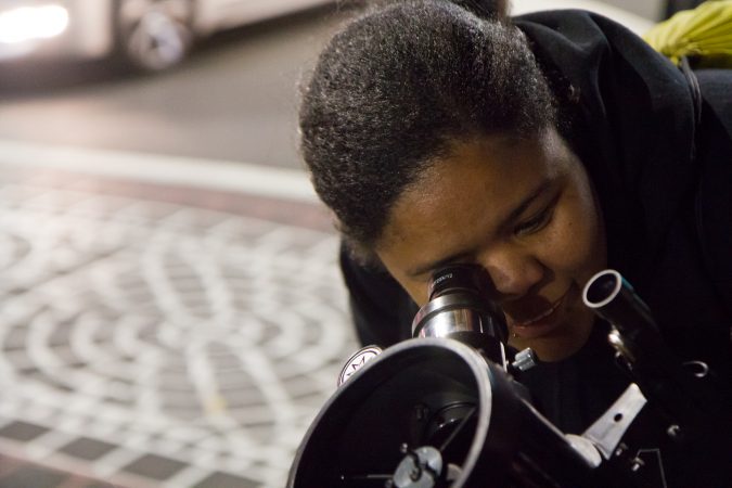 The Philadelphia Moon Men invite people on the streets of Philadelphia to gaze at the moon. (Kimberly Paynter/WHYY)