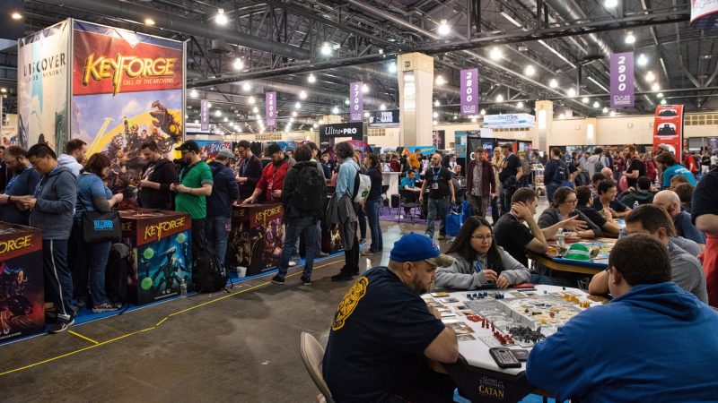 Convention goers at PAX Unplugged try out the latest games that vendors have set out for testing on the showroom floor. (Kriston Jae Bethel for WHYY)