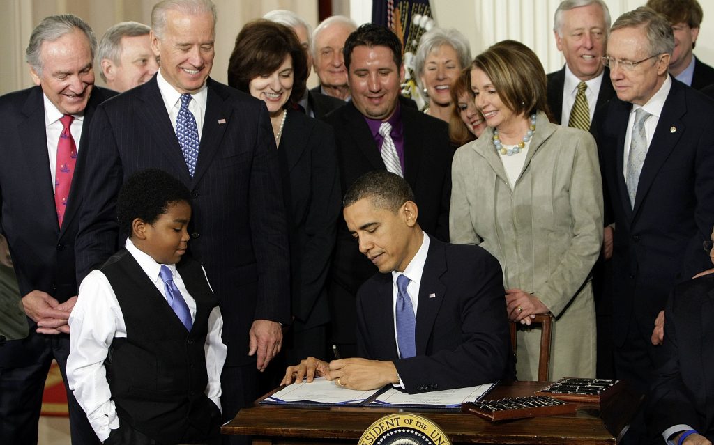Obama Legacy Race FILE - In this Tuesday, March 23, 2010 file photo, President Barack Obama signs the Patient Protection and Affordable Care Act in the East Room of the White House in Washington. (AP Photo/J. Scott Applewhite)