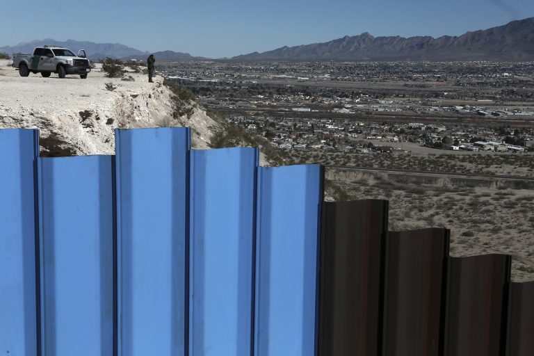  In this Jan. 25, 2017, file photo, an agent from the border patrol, observes near the Mexico-US border fence, on the Mexican side, separating the towns of Anapra, Mexico and Sunland Park, N.M. An 8-year-old boy from Guatemala died in government custody early Tuesday, Dec. 25, 2018, U.S. immigration authorities said. (AP Photo/Christian Torres, File)