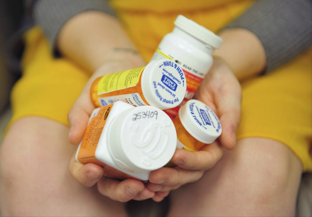Overcoming Opioids Better Drugs Heidi Wyandt, 27, holds a handful of her medication bottles at the Altoona Center for Clinical Research in Altoona, Pa., on Wednesday, March 29, 2017, where she is helping test an experimental non-opioid pain medication for chronic back pain related to a work related injury she received in 2014. (Chris Post/AP Photo)