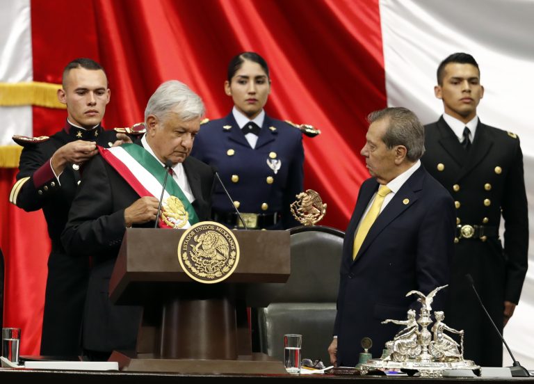 Mexico's new President Andres Manuel Lopez Obrador, (left), receives the presidential sash as Porfirio Munoz Ledo, president of the Congress, (right), looks on during the inaugural ceremony at the National Congress in Mexico City, Saturday, Dec. 1, 2018. (Eduardo Verdugo/AP Photo)
