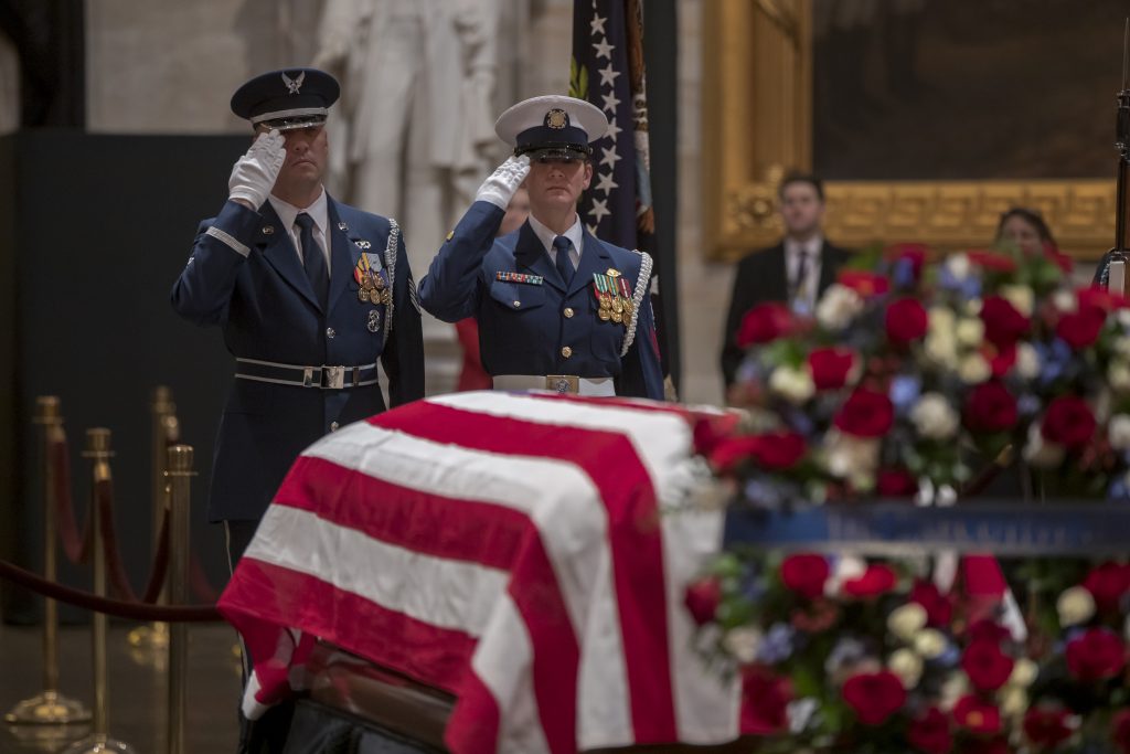 George HW Bush A final salute is rendered by the honor guard standing watch over the flag-draped casket of the late president, George H.W. Bush, as the public viewing comes to an end at the U.S. Capitol Rotunda, Wednesday, Dec. 5, 2018. (AP Photo/J. Scott Applewhite)