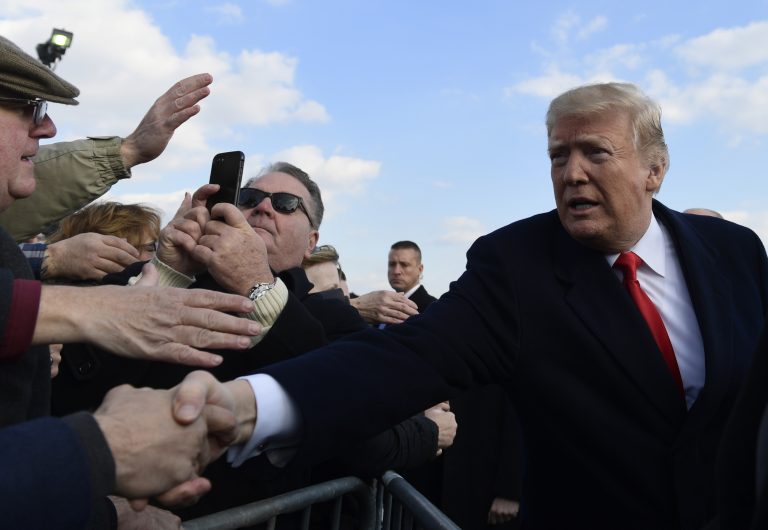 President Donald Trump greets people after arriving via Air Force One at Philadelphia International Airport in Philadelphia, Saturday, Dec. 8, 2018. Trump is attending the Army-Navy football game. (Susan Walsh/AP Photo)