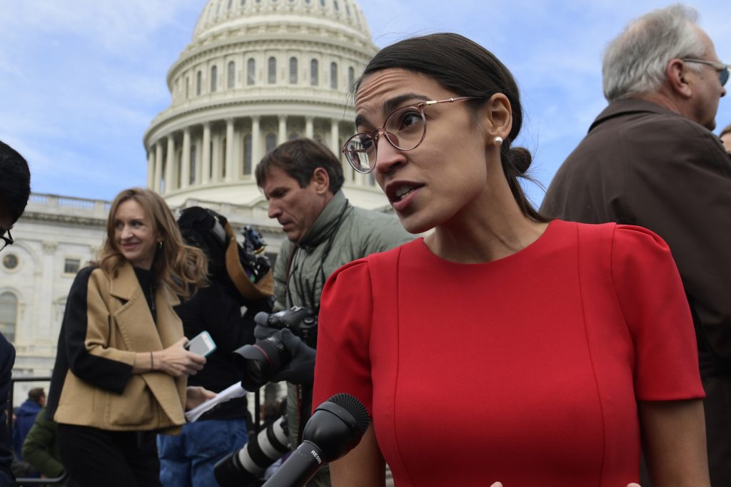 Alexandria Ocasio-Cortez In this Nov. 14, 2018 photo, Rep.-elect Alexandria Ocasio-Cortez, D-N.Y., talks with reporters following a photo opportunity on Capitol Hill in Washington. While tea party Republicans swept to power to stop things -- repeal Obamacare, roll back environmental regulations and decrease the size and scope of government -- Democrats are marching into the majority to build things back up. And after spending eight downcast years in the minority, they can’t wait to get started. (AP Photo/Susan Walsh)