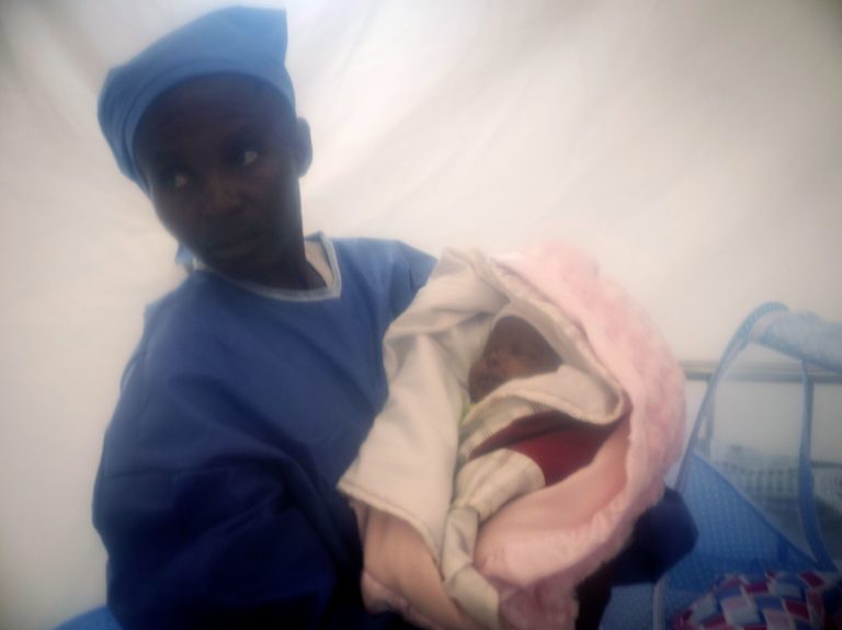 In this photograph taken Dec. 3, 2018 and released by UNICEF, an Ebola survivor cares for one week-old Benedicte who was infected at birth with the Ebola virus by her mother, at an Ebola treatment center in Beni, Democratic Republic of the Congo. Benedicte's mother died. The child, who has recovered from the virus, is now called the 