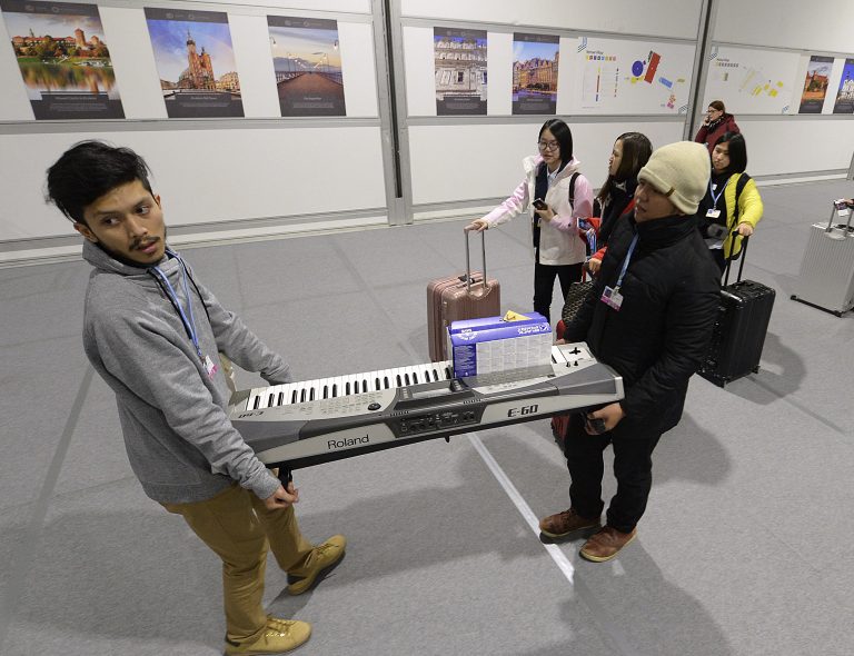 Participants leave before the end of the final session of the COP24 summit on climate change in Katowice, Poland on Friday, Dec. 14. (Czarek Sokolowski/AP)