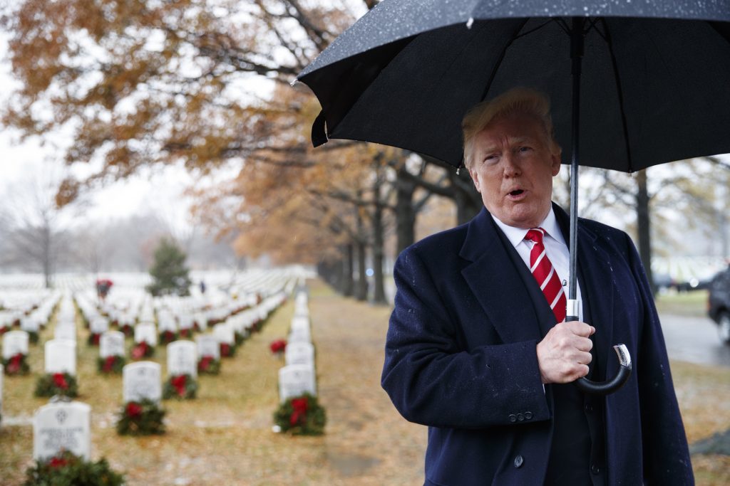 Donald Trump President Donald Trump speaks to media as he visits Section 60 at Arlington National Cemetery in Arlington, Va. on Dec. 15, during Wreaths Across America Day. (Carolyn Kaster/AP)