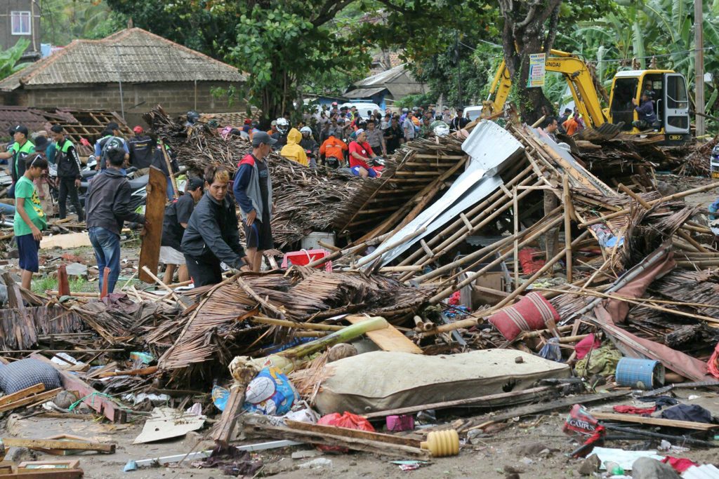 APTOPIX Indonesia Tsunami Residents inspect a house damaged by a tsunami, in Carita, Indonesia, Sunday, Dec. 23, 2018. The tsunami apparently caused by the eruption of an island volcano killed a number of people around Indonesia's Sunda Strait, sending a wall of water crashing some 65 feet (20 meters) inland and sweeping away hundreds of houses including hotels, the government and witnesses said. (AP Photo)