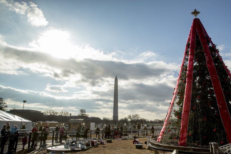 Visitors to the National Christmas Tree on the Ellipse look at holiday decorations as National Park Service employees briefly open the venue before quickly having to close again due to electrical problems, Monday, Dec. 24, 2018, in Washington. Repairs were delayed because of a partial government shutdown. Both sides in the long-running fight over funding President Donald Trump's U.S.-Mexico border wall appear to have moved toward each other, but a shutdown of one-fourth of the federal government entered Christmas without a clear resolution in sight. (Andrew Harnik/AP)