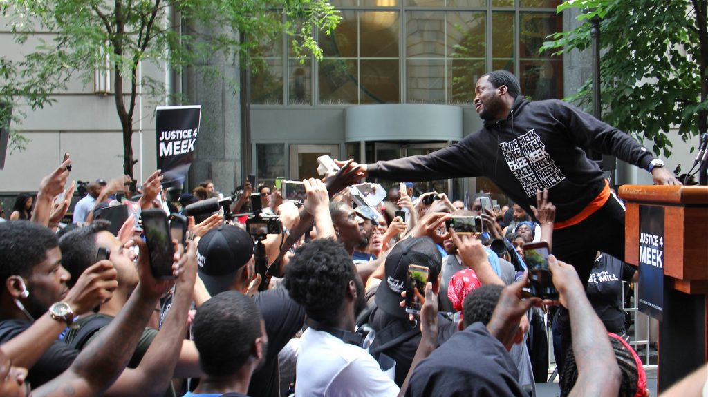 Meek Mill reaches out to supporters outside the Criminal Justice Center on June 18, 2018, before his hearing to ask for a new trial on 10-year-old gun and drug charges. (Emma Lee/WHYY)