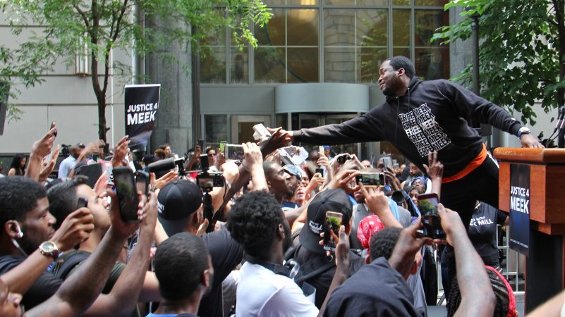 Meek Mill reaches out to supporters outside the Criminal Justice Center on June 18, 2018, before his hearing to ask for a new trial on 10-year-old gun and drug charges. (Emma Lee/WHYY)