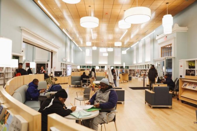 Logan Library's renovation opened up the double-height main room and now has casual, movable furniture (Neal Santos for PlanPhilly)