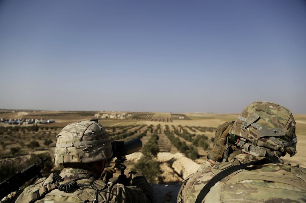 American troops look toward the border with Turkey from a small outpost near the town of Manbij, northern Syria, in February. American troops look toward the border with Turkey from a small outpost near the town of Manbij, northern Syria, in February. (Susannah George/AP)