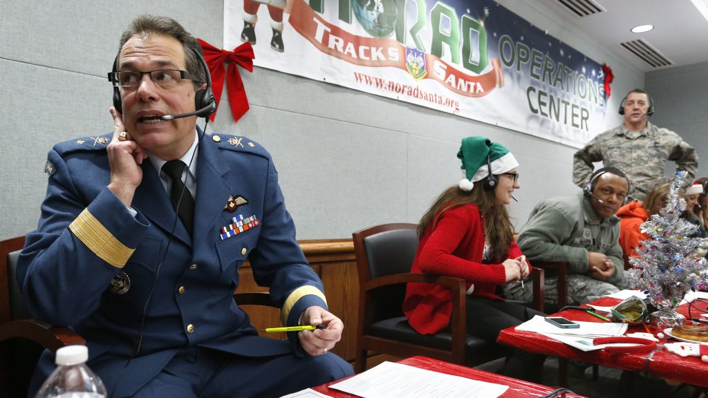 Every year, NORAD staff and volunteers field calls from children inquiring about Santa. Canadian Brig. Gen Guy Hamel joined in the tradition in 2014. Every year, NORAD staff and volunteers field calls from children inquiring about Santa. Canadian Brig. Gen Guy Hamel joined in the tradition in 2014. (Brennan Linsley/AP)