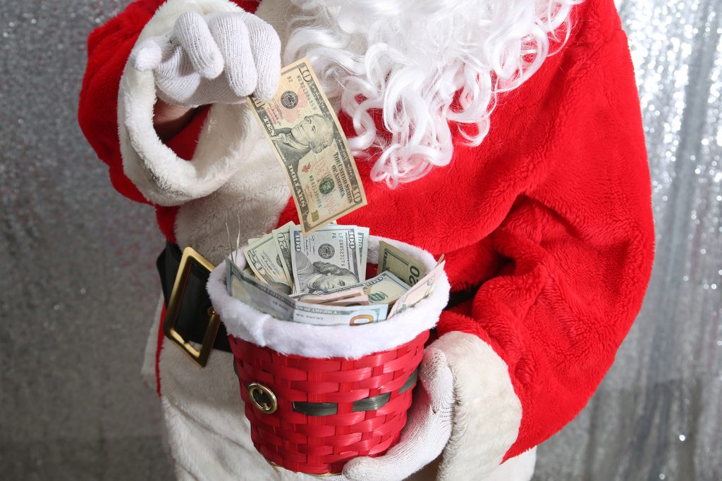 Santa Claus. Christmas Charity and Donations. Santa collects money for the needy or donations for the poor. Collection Plate.