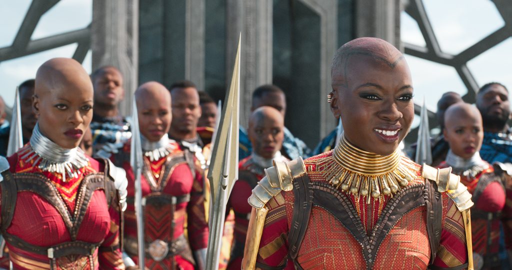 Ayo (Florence Kasumba, left) and Okoye (Danai Gurira) are members of the Dora Milaje, the elite female warriors of Wakanda, in Black Panther. Ayo (Florence Kasumba, left) and Okoye (Danai Gurira) are members of the Dora Milaje, the elite female warriors of Wakanda, in Black Panther.</em