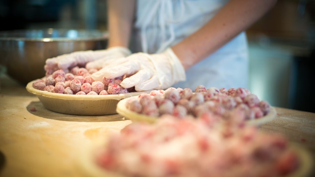 An employee at Grand Traverse Pie Co. in Michigan makes cherry pies. The company has been shipping pies since 1998, when people still had to phone in their orders. An employee at Grand Traverse Pie Co. in Michigan makes cherry pies. The company has been shipping pies since 1998, when people still had to phone in their orders. (Beryl Striewski/Grand Traverse Pie Co.)