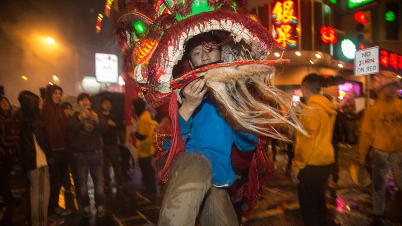 A member of the Philly Suns does a lion dance through the streets of Chinatown in celebration of the Chinese New Year on Feb. 15, 2018. (Emily Cohen for WHYY)
