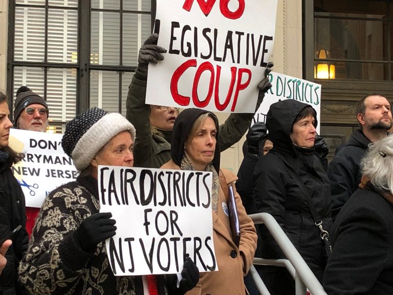 Protesters picket outside the N.J. State House in Trenton minutes before legislators hold public hearings on a controversial redistricting plan. (Joe Hernandez/WHYY)