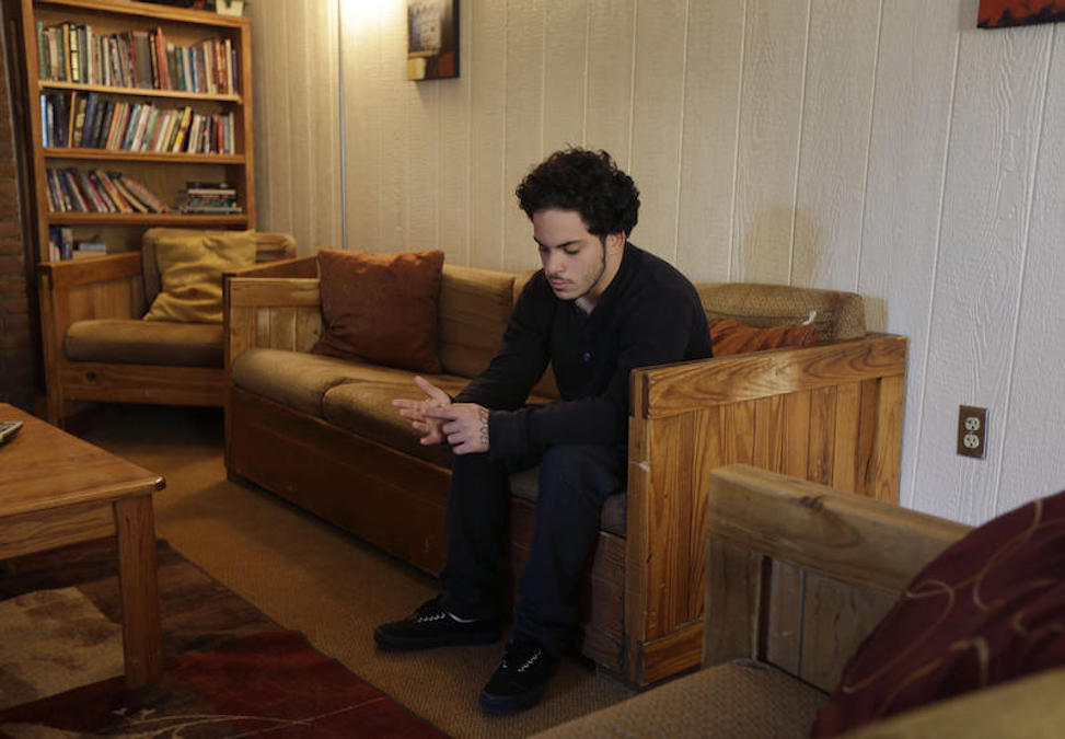 Foster Care Group Homes In this Thursday, April 24, 2014 photo, Jose Osario, 20, a resident of the transition cottage, sits in the living room of another cottage at the Children's Village campus in Dobbs Ferry, N.Y. (AP Photo/Seth Wenig)