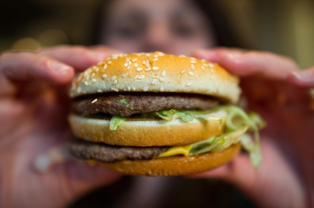 A customer holds a McDonald’s Big Mac. The fast-food giant, one of the world’s biggest beef buyers, has announced plans to use its might to cut back on antibiotics in its global beef supply. Environmentalists are applauding the commitment. A customer holds a McDonald's Big Mac. The fast-food giant, one of the world's biggest beef buyers, has announced plans to use its might to cut back on antibiotics in its global beef supply. Environmentalists are applauding the commitment. (Christoph Schmidt/Picture Alliance via Getty Images)