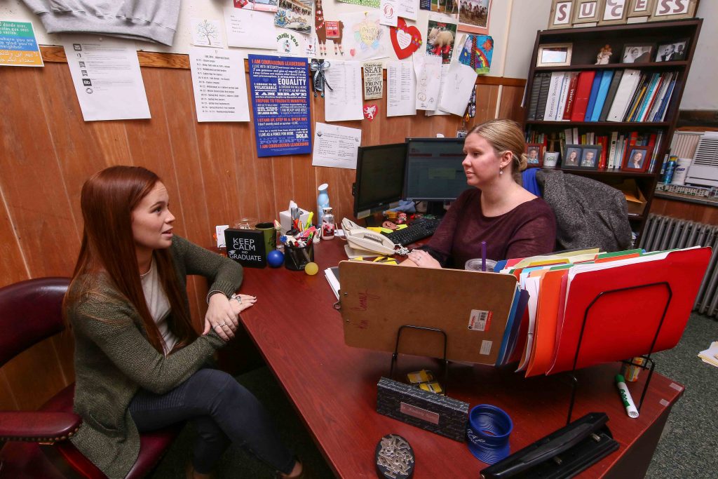 College students almost always think theyÕll finish in four years, but fewer than half of them do. One reason is that they take so long to choose a major. Kim Cooney, director of student success at Chestnut Hill College, meets with senior Erin Crowley. After changing her major, she took extra classes so she could graduate on time. Chestnut Hill started a program this year to get more students to choose a major by sophomore year. (Saquan Stimpson for The Hechinger Report)